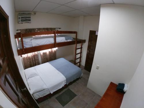 a small room with two bunk beds in it at Hotel Estación del Sol in Las Núñez