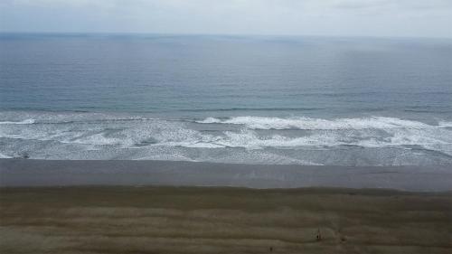an aerial view of the ocean with waves at Hotel Estación del Sol in Las Núñez