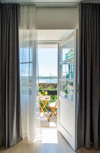 a door leading to a balcony with a view at New central studio - La Mer in Šibenik
