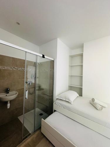 La petite salle de bains est pourvue d'une douche et d'un lavabo. dans l'établissement Les luxueuses terrasses du Roucas, à Marseille