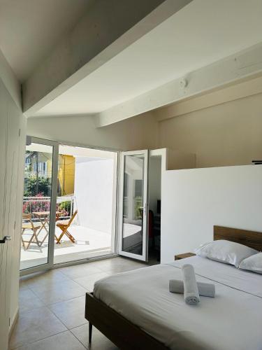 - une chambre avec un lit et une vue sur une terrasse dans l'établissement Les luxueuses terrasses du Roucas, à Marseille