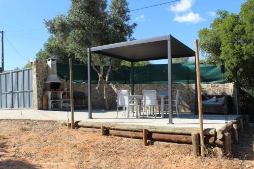 a pavilion with a table and chairs in a yard at Casa de Campo Dias in Silves