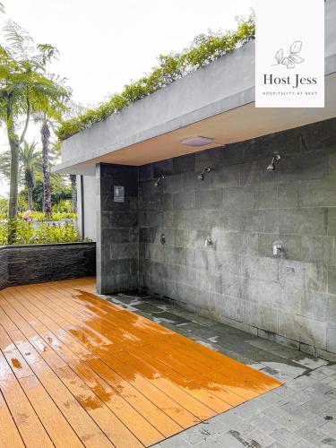 a patio with a wooden floor and a building at Gold Coast PIK Apartments by Host Jess in Jakarta