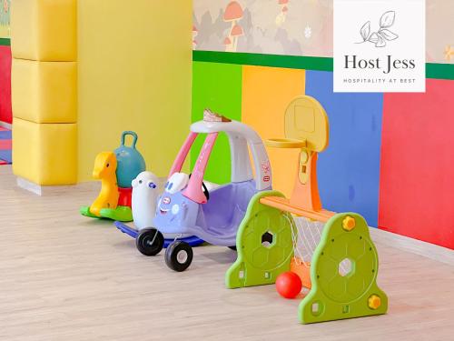 a group of toys on the floor in a room at Gold Coast PIK Apartments by Host Jess in Jakarta