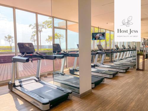 a row of treadmills in a gym at Gold Coast PIK Apartments by Host Jess in Jakarta