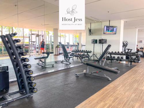 a gym with rows of treadmills and exercise machines at Gold Coast PIK Apartments by Host Jess in Jakarta