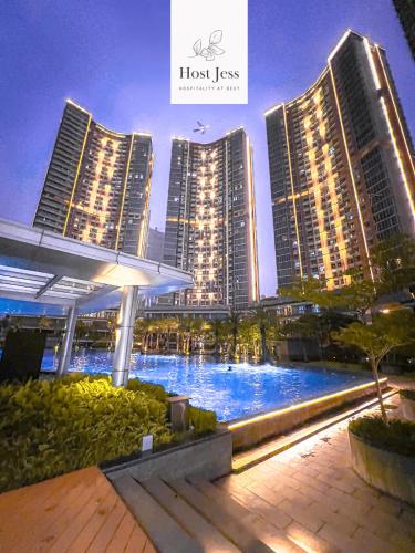 a large pool in front of some tall buildings at Gold Coast PIK Apartments by Host Jess in Jakarta