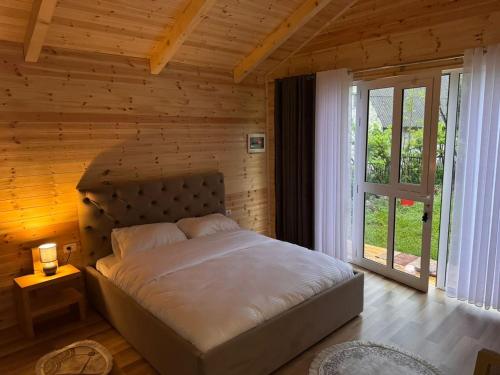 a bedroom with a bed in a wooden room at Thethi Mountain Villas in Theth