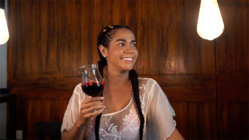 a woman holding a glass of red wine at Hotel Estación del Sol in Las Núñez