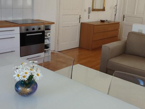a vase of flowers on a table in a kitchen at Bellvedere in Tivat