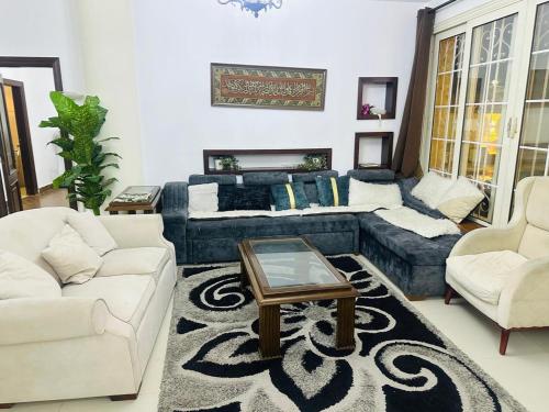 a living room with a couch and a table at فيلا كينج مريوط in King Mariout