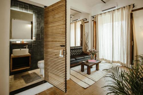a bathroom with a toilet and a bench in a room at Hotel Sin Nombre in Oaxaca City