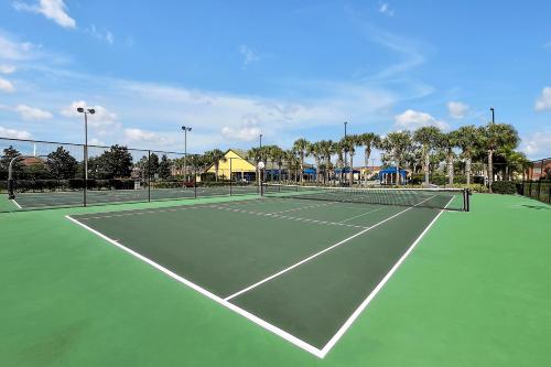 a tennis court with two tennis nets on it at Trendy Retreat - Great Location - Fully Loaded in Kissimmee