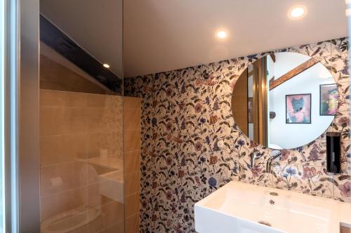 a bathroom with a sink and a mirror at ISSA Lesvos in Mytilini