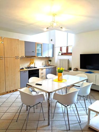 a kitchen and dining room with a table and chairs at Old Town Apartment with Terrace - Live Love Lake in Peschiera del Garda