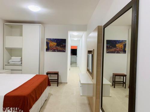 a bedroom with a bed and a mirror at Lagamar Hotel Varginha in Varginha