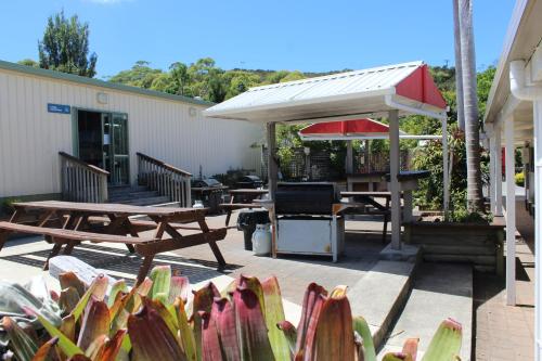 a patio with a picnic table and a pavilion at Whatuwhiwhi TOP 10 Holiday Park in Tokerau Beach