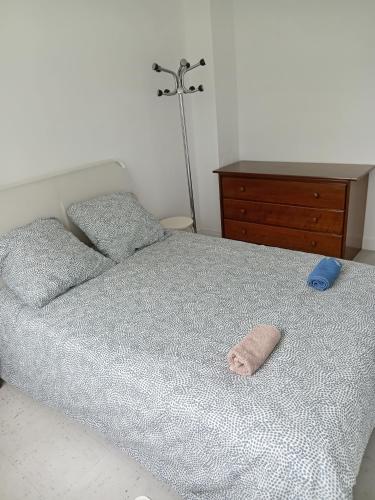 a bedroom with a bed with a pillow and a dresser at Chambre double confort in Paris