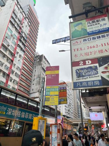 a busy city street with many signs and buildings at 铜锣湾近地铁巴士交通便利宽敞舒适自助入住 in Hong Kong