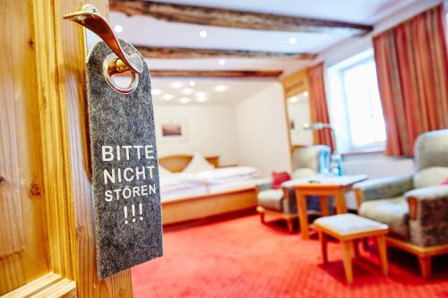a hotel room with a sign on a door at Landhotel Voss im TalVital in Saalhausen