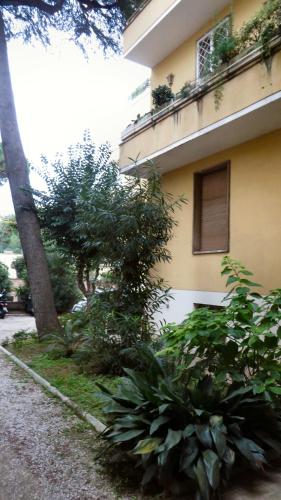 a building with a bunch of plants next to a street at Guest's Heaven in Rome