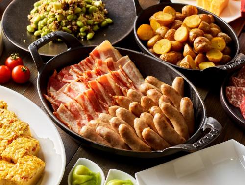 a table with three pans of food with different foods at Hyatt Regency Tokyo Bay in Urayasu