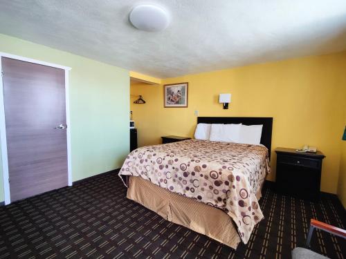 a hotel room with a bed and a door at Desert Inn in Van Horn