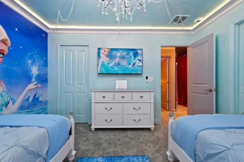a bedroom with two beds and a painting on the wall at Top 5 percent Luxury Villa at Storey Lake mins to Disney in Kissimmee