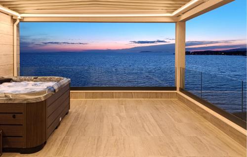 a bedroom with a view of the ocean at Cozy Apartment In Povljana With Wifi in Povljana