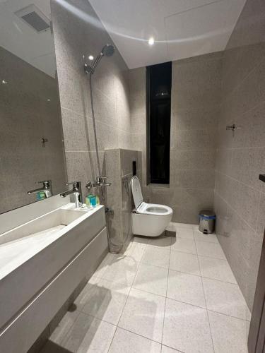 a bathroom with a toilet and a sink and a shower at Anwar AlBaraka Hotel in Al Madinah
