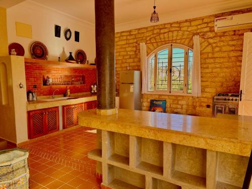 a kitchen with a counter top in a room at QUIET OASIS Luxury Stone Villa with Panoramic Views near Essaouira in Essaouira