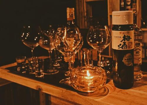 a group of wine glasses on a table with a candle at Tà Xùa Haus Meej Homestay in Bắc Yên