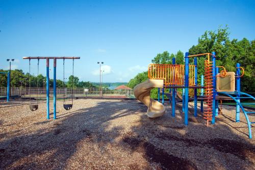 a playground with a slide in a park at Barren River Lake State Resort Park in Lucas