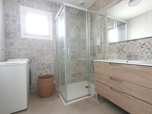 une salle de bain avec douche et lavabo dans l'établissement Maison plain-pied à 400m de la plage avec jardin, WiFi et garage - 3 étoiles Clévacances - FR-1-476-159, à La Faute-sur-Mer