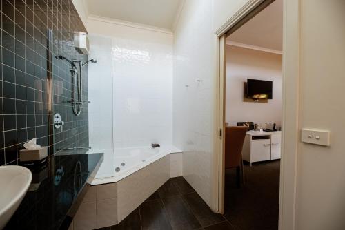 a bathroom with a shower and a sink at Alexandra Place in Bendigo