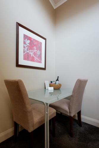 a dining room with a table and two chairs at Alexandra Place in Bendigo