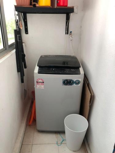a small stove in a corner of a room at DRIFF Homestay 3bedroom with aircond 50m to Night Market Wakaf Che Yeh in Kota Bharu