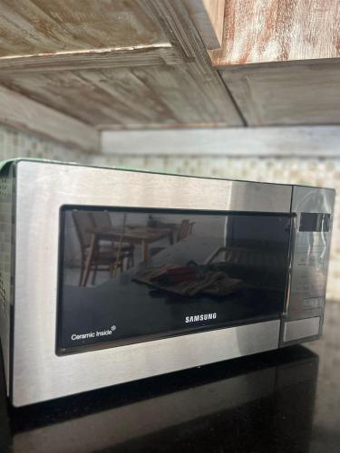 a microwave oven sitting on top of a table at Villa Lemone by Bali Villa Solutions in Seminyak
