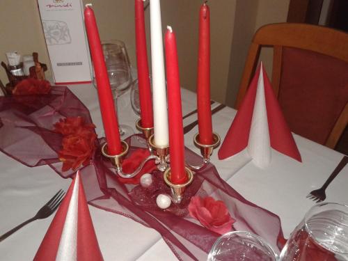a group of red candles on a table at Hotel Vila Anna in Trenčianske Teplice