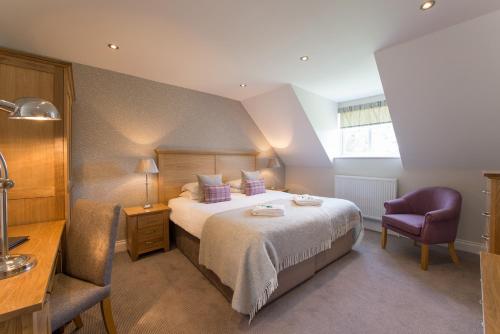 Una cama o camas en una habitación de Beaulieu Hotel