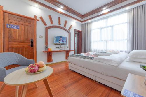 a bedroom with a bed and a table with a plate of food at Easy House Gaoyun Branch in Zhangjiajie