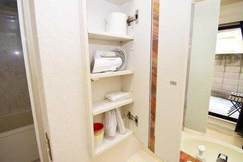 baño con estantes blancos y lavamanos en KITAZAWA CS HOUSE - Vacation STAY 45470v, en Tokio