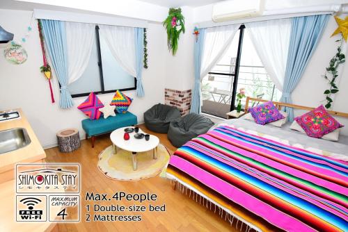 a living room with a bed and a table at KITAZAWA CS HOUSE / Vacation STAY 65310 in Tokyo