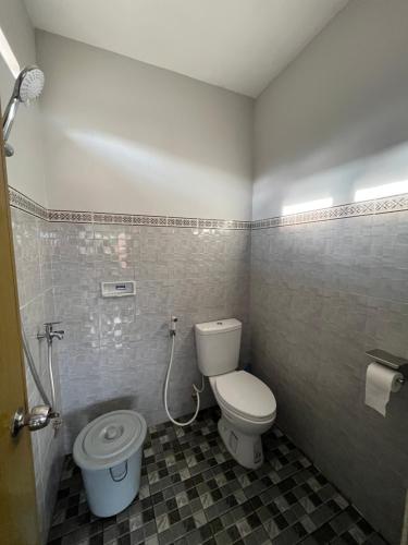a bathroom with a toilet and a shower in it at Gemyah in Glagah