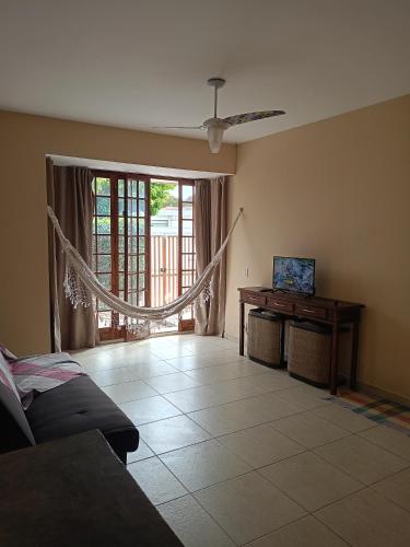 a living room with a couch and a table and a window at Casa inteira no Centro de Jacareí próximo à São José dos Campos in Jacareí