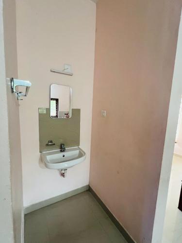 a bathroom with a sink and a mirror at Kadampil Bliss in Marayoor