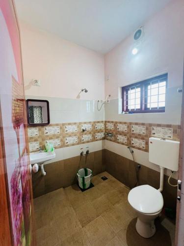 a bathroom with a toilet and a sink at Kadampil Bliss in Marayoor