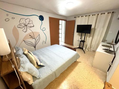 Bee Inn Puerto Rico Charming Urban Apartment in San Juan في سان خوان: غرفة نوم بسرير جداري عليه ورد