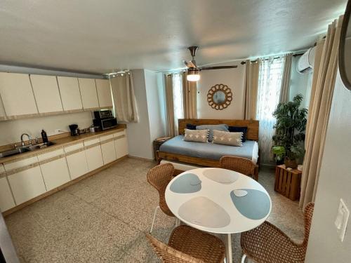 a kitchen and a living room with a table and a bed at Charming Centric Apartment in San Juan in San Juan