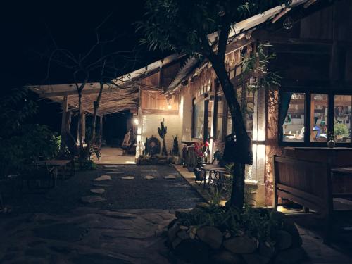 a building with a tree in front of it at night at Pavi garden in Sa Pa